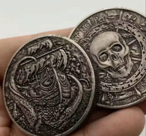 A picture of two coins. One shows a ship about to be dragged under by a kraken. The other shows a skull